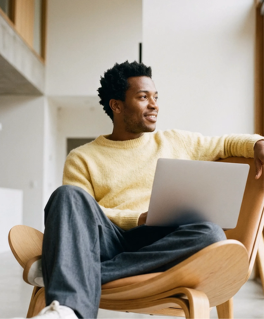 A person sitting with a laptop.
