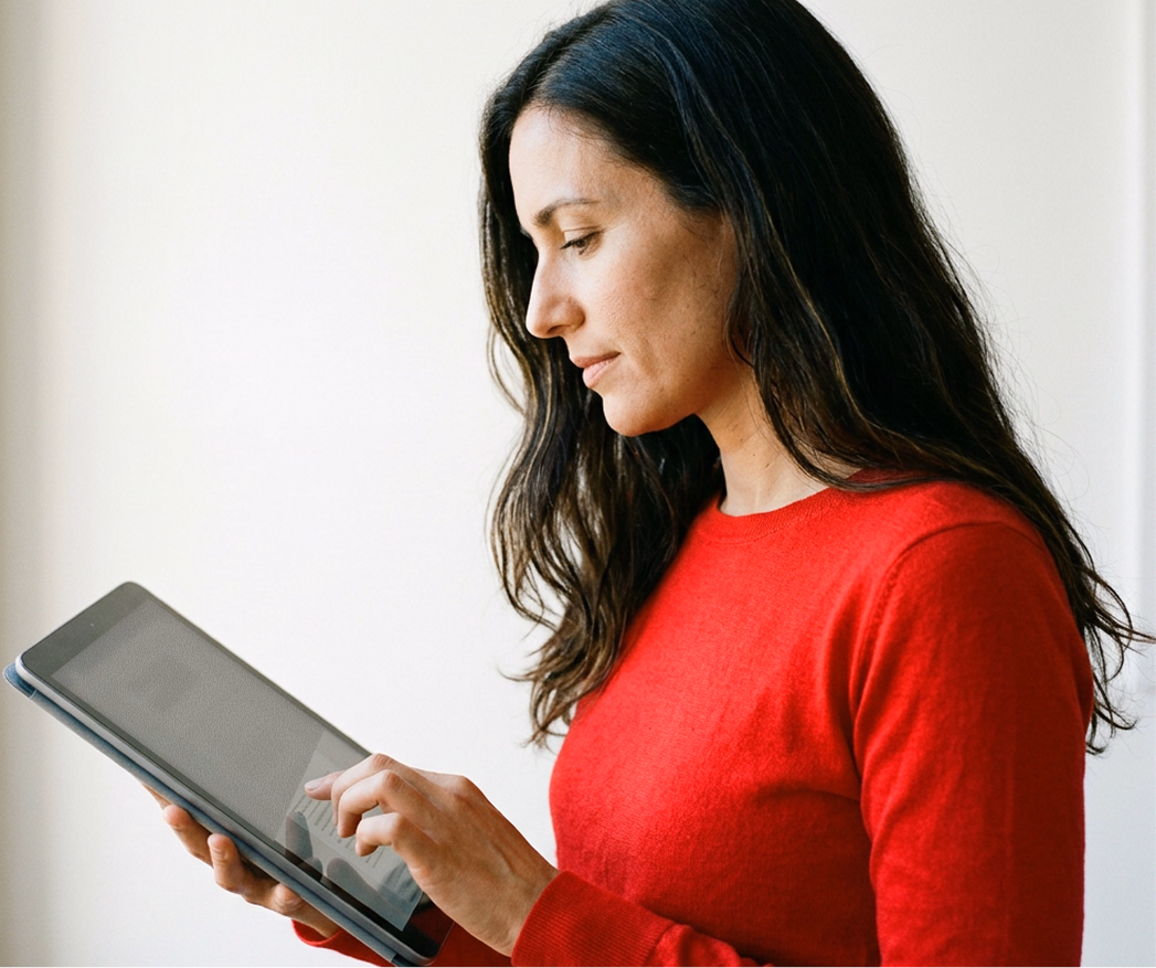 A person reviewing an assessment on a tablet.